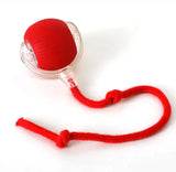 Red interactive pet toy with a string attachment for keeping cats and dogs active, ideal for indoor play and engagement.